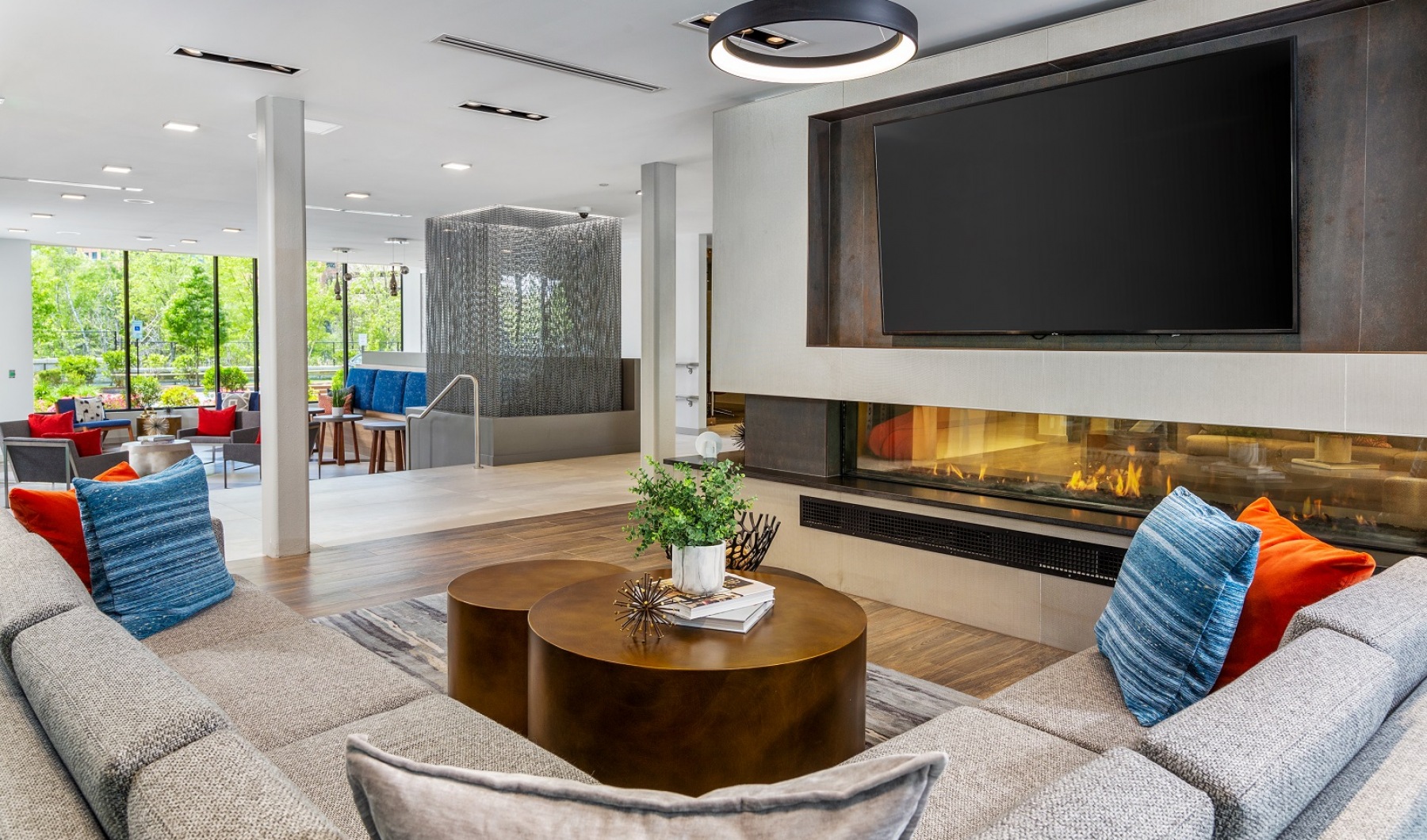 Emery Flats Clubroom Resident lounge area with fireplace, flatscreen TV and seating